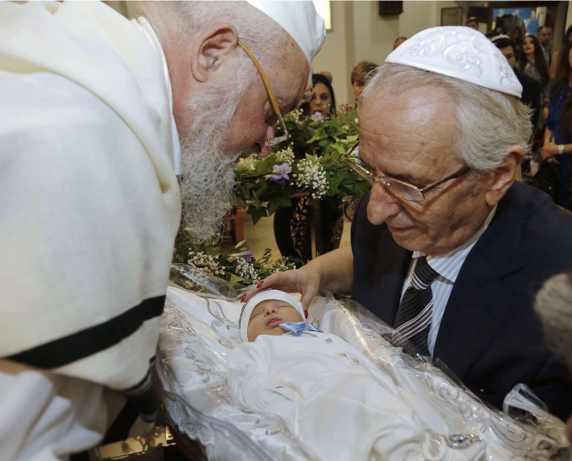 mohel with a baby and the Rabi